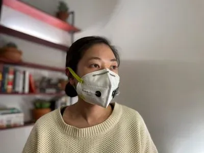 photograph of a woman wearing a face mask embedded with SARS-CoV-2 sensors